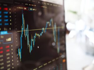 Price chart on a monitor showing candlestick market analysis and price movement.