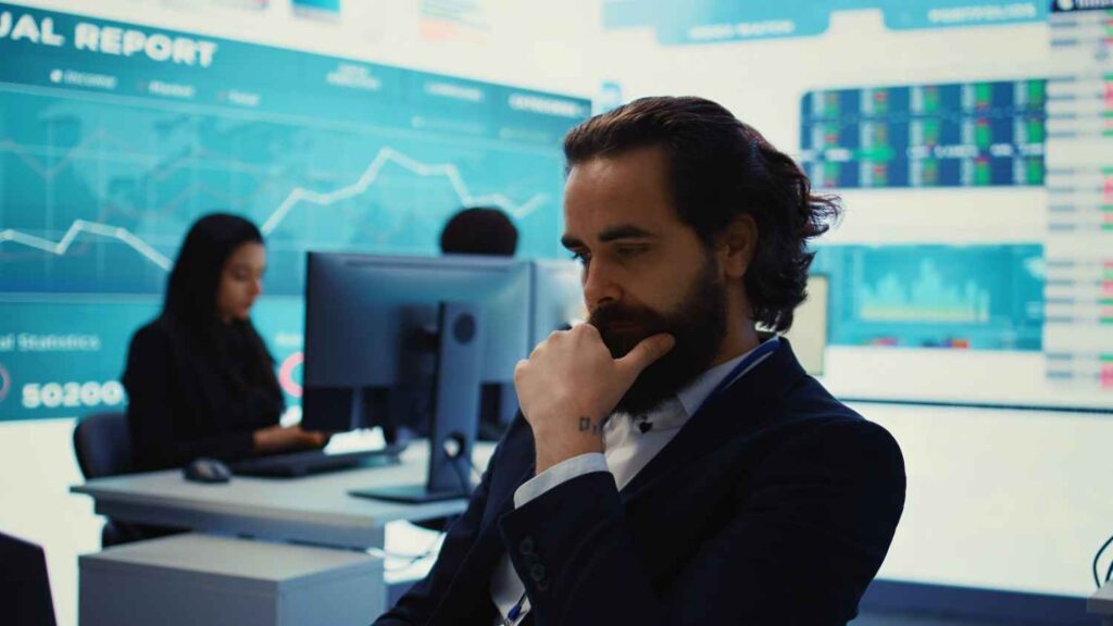 Trader deeply analyzing market charts and financial data, illustrating how emotional attachment to a market bias can influence trading decisions and reduce objectivity.