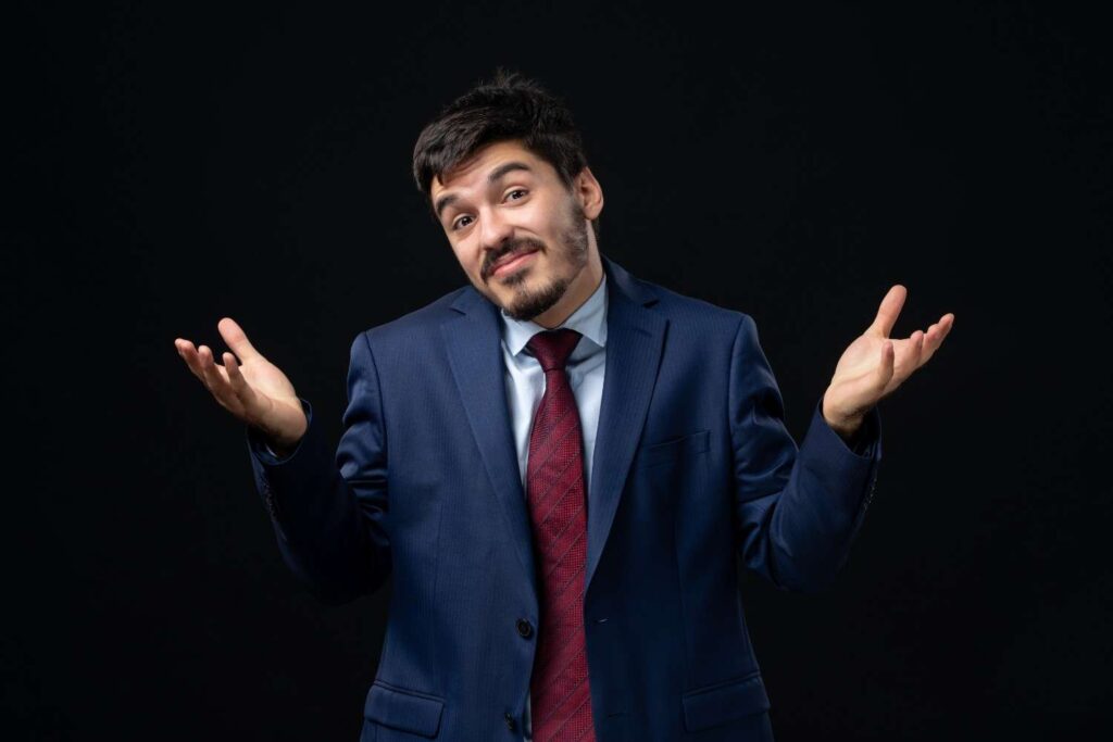 Trader shrugging with a calm expression, illustrating the acceptance of uncertainty and unpredictable market outcomes in trading.
