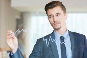 Trader calmly reviewing market charts and trade setups, illustrating how focusing on the trading process helps improve trading psychology by reducing emotional decision-making, fear, greed, and performance pressure.