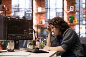 Trader reviewing market charts and trade outcomes with a focused mindset, illustrating how trading psychology is affected by emotional reactions to wins, losses, discipline, and decision-making in the financial markets.