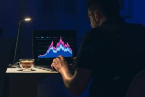 A conceptual image depicting a trader or professional staring at multiple screens filled with charts and data, appearing busy but unfocused, symbolizing the illusion of productivity where constant activity is mistaken for real progress while meaningful decision-making is absent.