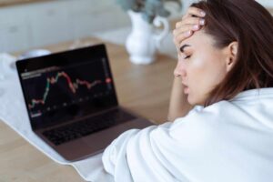 Trader constantly searching for trading opportunities and monitoring charts, illustrating the problem with always needing action and how excessive market participation can lead to overtrading and poor decision-making.