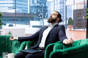 A calm, focused trader sitting relaxed in front of a clean trading setup with minimal screen activity, symbolizing professional discipline, patience, and comfort in waiting for high-quality market opportunities instead of forcing trades.