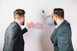 Trader focused on market charts while analyzing price movements, illustrating how emotional attachment to a market bias can influence decision-making and make it difficult to adapt to changing market conditions.