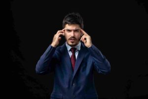 Trader confidently analyzing market charts while ignoring changing price action, illustrating how traders often confuse healthy conviction with stubbornness by refusing to adapt their market view despite new evidence.