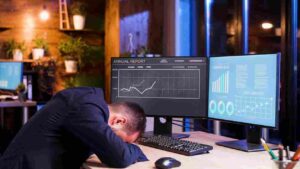Trader looking disappointed while reviewing a losing trade on market charts, illustrating why many traders take losses personally by connecting trade outcomes to their confidence and self-worth.