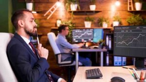 Trader confidently analyzing market charts and indicators, illustrating why traders develop the belief that experience, analysis, and successful trades allow them to control or accurately predict market movements.